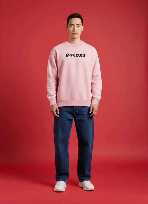Virtual model in pink Veeton sweatshirt and dark jeans on red studio background