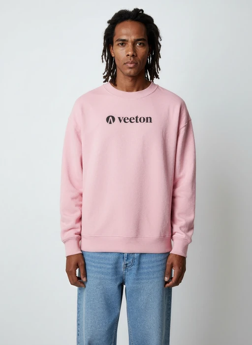 Virtual model wearing pink Veeton sweatshirt and beige trousers with dramatic window lighting