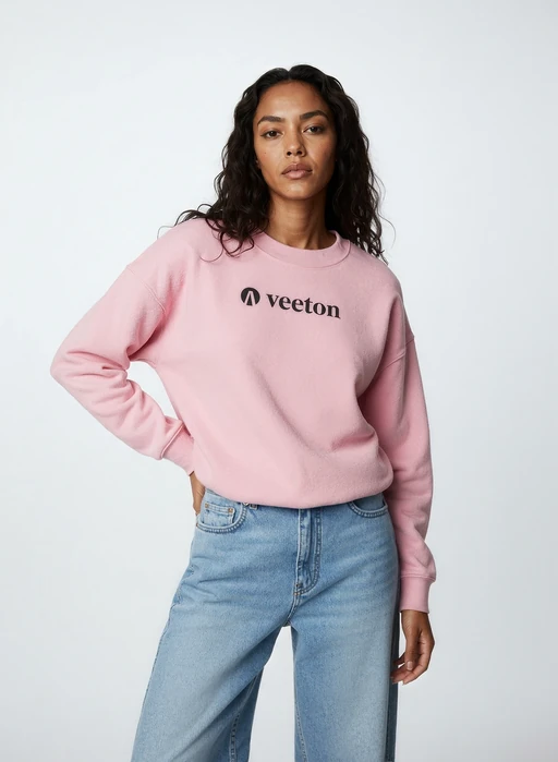 AI-generated model with long black hair in pink Veeton sweatshirt and light blue jeans