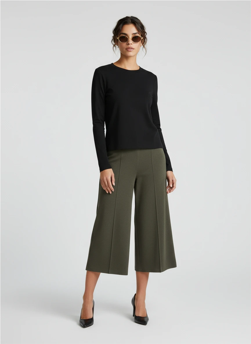 AI model wearing a black sweater and olive trousers.